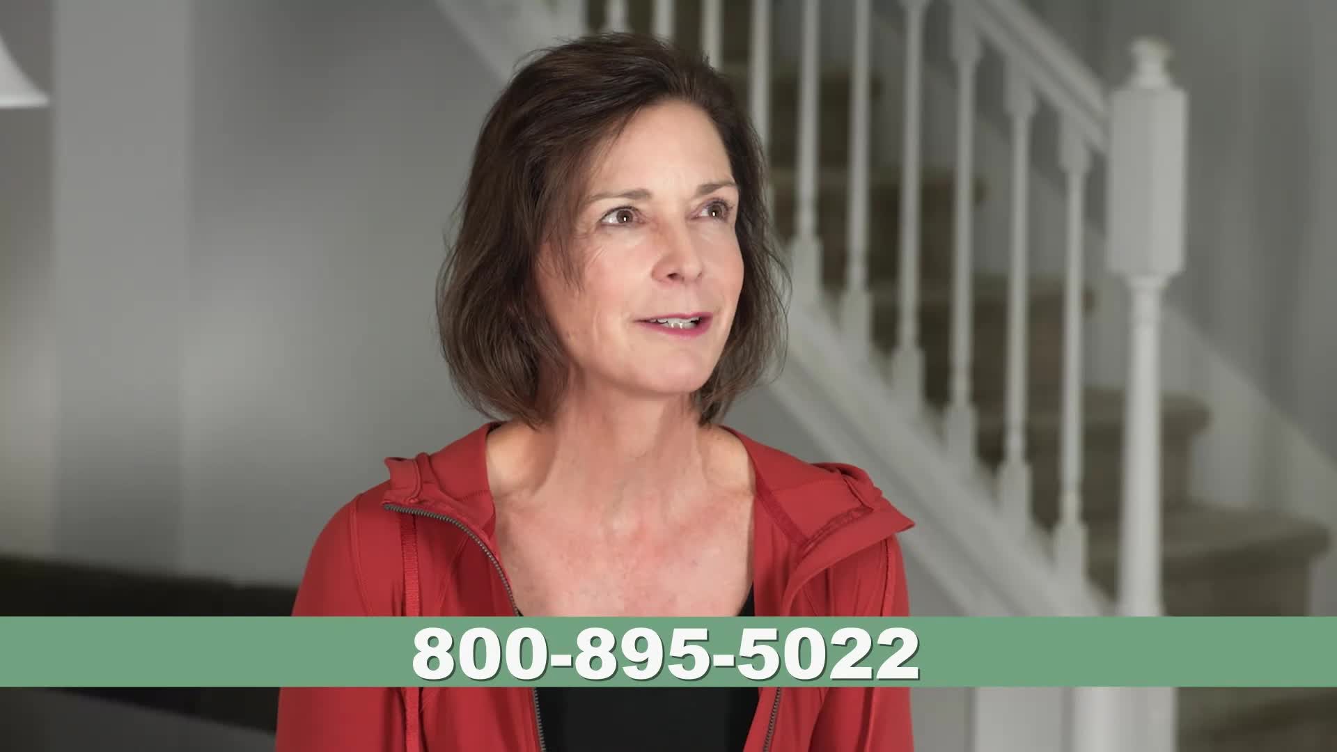 A woman in a red jacket speaks, her gaze directed slightly off-camera. A phone number, 800-895-5022, appears across the bottom of the screen. A woman in a red jacket speaks, her gaze directed slightly off-camera. A phone number, 800-895-5022, appears across the bottom of the screen.