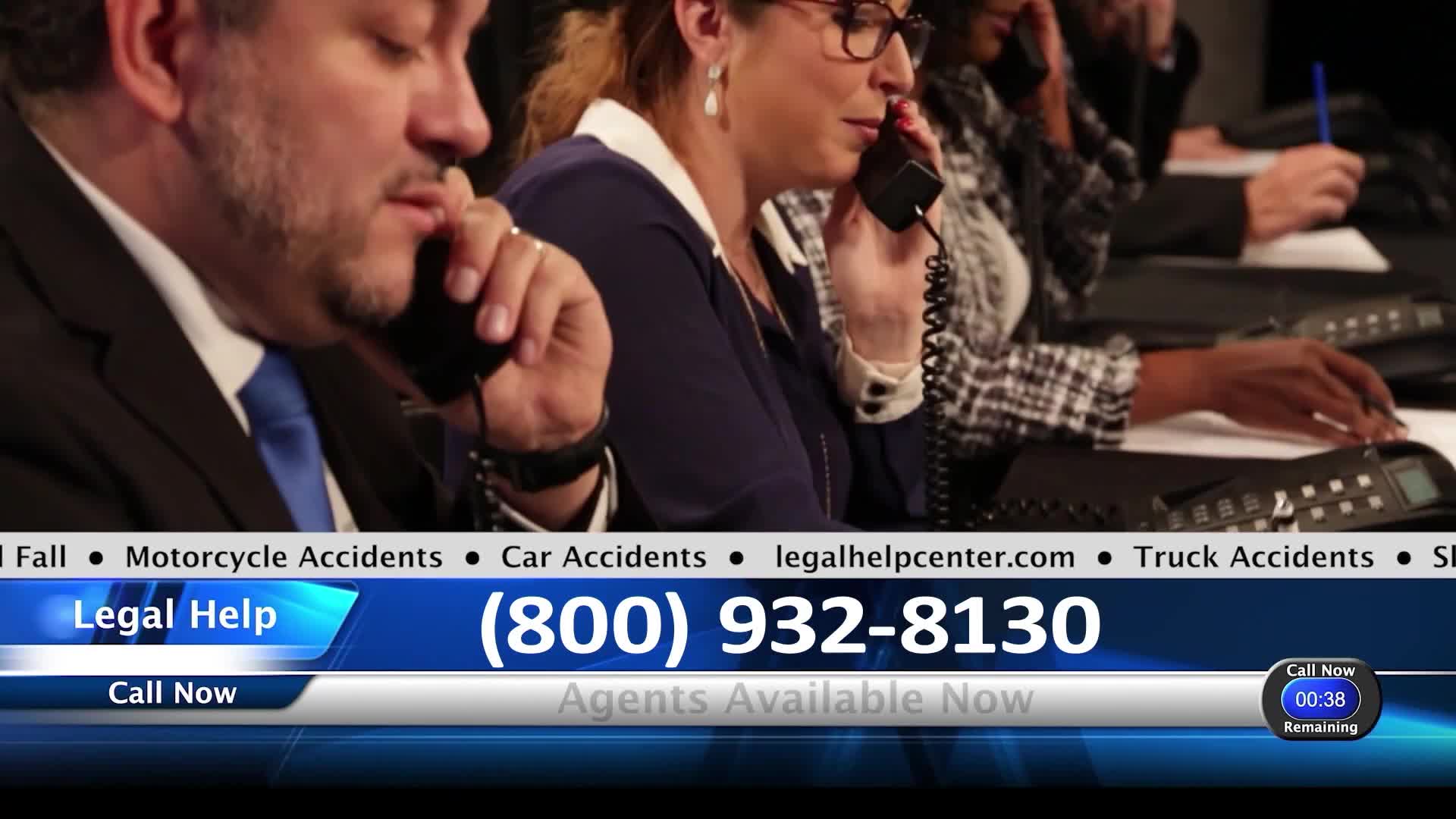 A man in a suit talks on his headset, his brow furrowed in concentration. Beside him, a woman in glasses speaks into her phone, her expression serious as she listens.