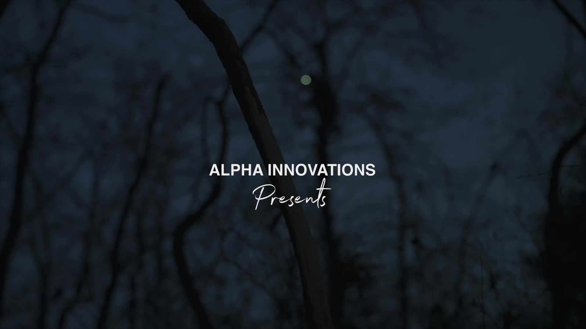 The screen displays "ALPHA INNOVATIONS Presents" over a dark, out-of-focus forest scene. A faint, distant light flickers high in the trees. The screen displays "ALPHA INNOVATIONS Presents" over a dark, out-of-focus forest scene. A faint, distant light flickers high in the trees.