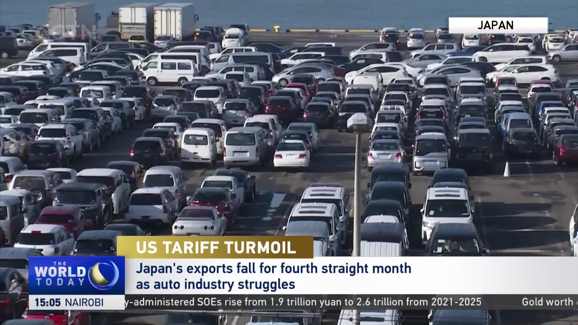 Rows of cars and vans fill a large lot, likely a port. A CGTN graphic reports on Japan's export struggles.
