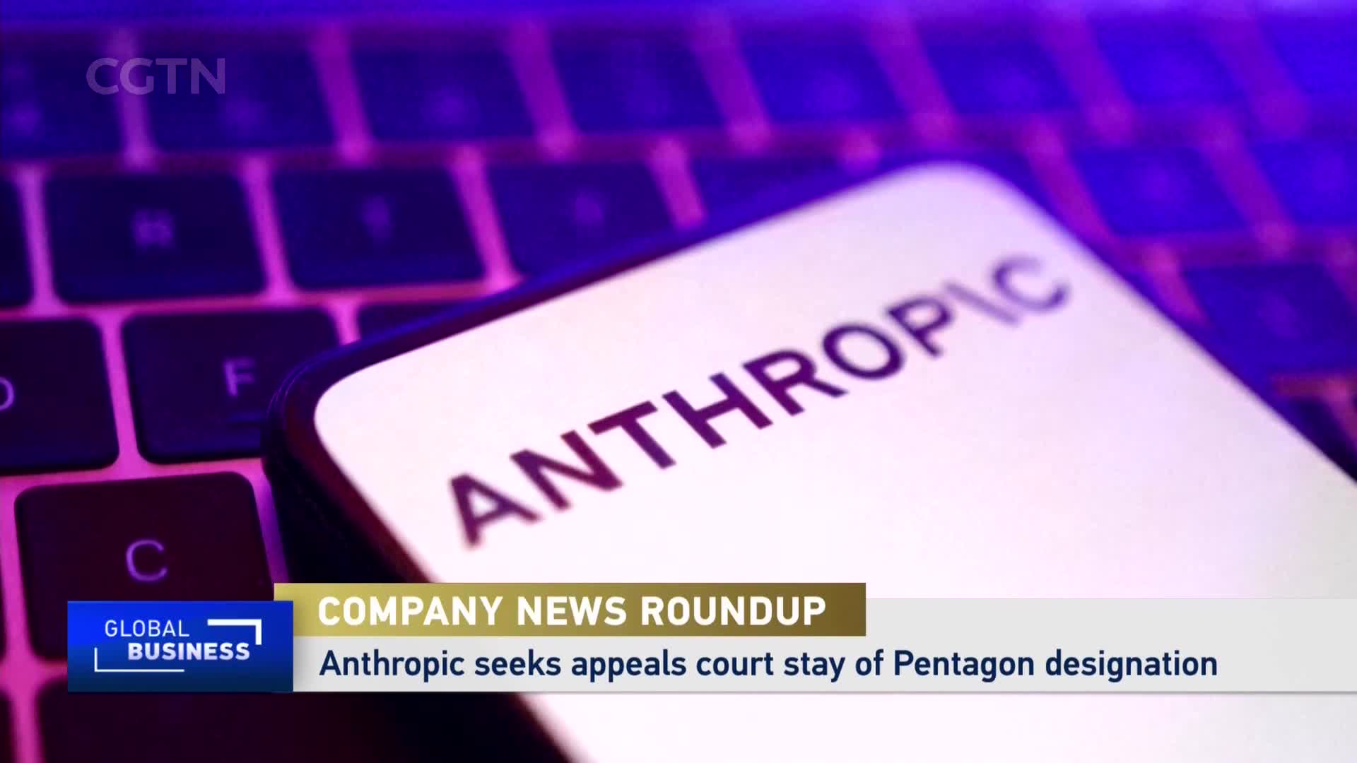 A phone screen displays "ANTHROPIC" in bold letters, resting on a keyboard bathed in purple light. Below, a CGTN "Global Business" chyron announces "COMPANY NEWS ROUNDUP" and a headline about Anthropic seeking a court stay.