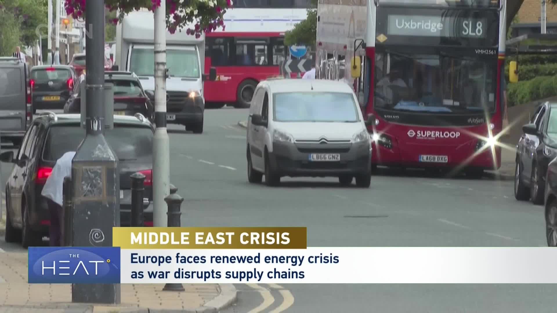 A red double-decker bus, marked "SUPERLOOP," cruises down the street, its headlights bright. Cars and vans navigate the road alongside it, a typical scene of urban transit. A red double-decker bus, marked "SUPERLOOP," cruises down the street, its headlights bright. Cars and vans navigate the road alongside it, a typical scene of urban transit.