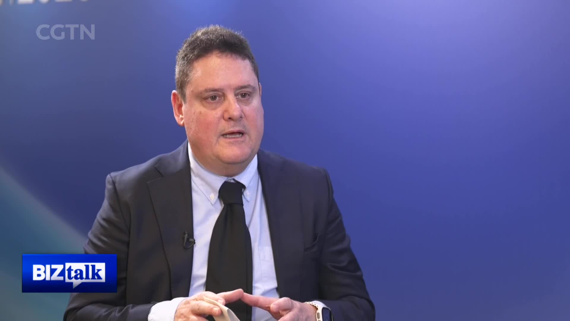 A man in a dark suit and black tie speaks, his hands gesturing slightly. The CGTN logo appears in the upper corner, with "BIZtalk" displayed at the bottom left. A man in a dark suit and black tie speaks, his hands gesturing slightly. The CGTN logo appears in the upper corner, with "BIZtalk" displayed at the bottom left.