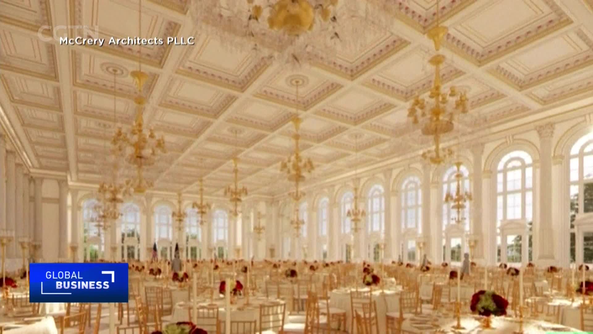 A vast ballroom stretches out, its ornate ceiling adorned with gilded chandeliers. Rows of tables, set for a grand event, fill the space, reflecting the bright light from the arched windows.