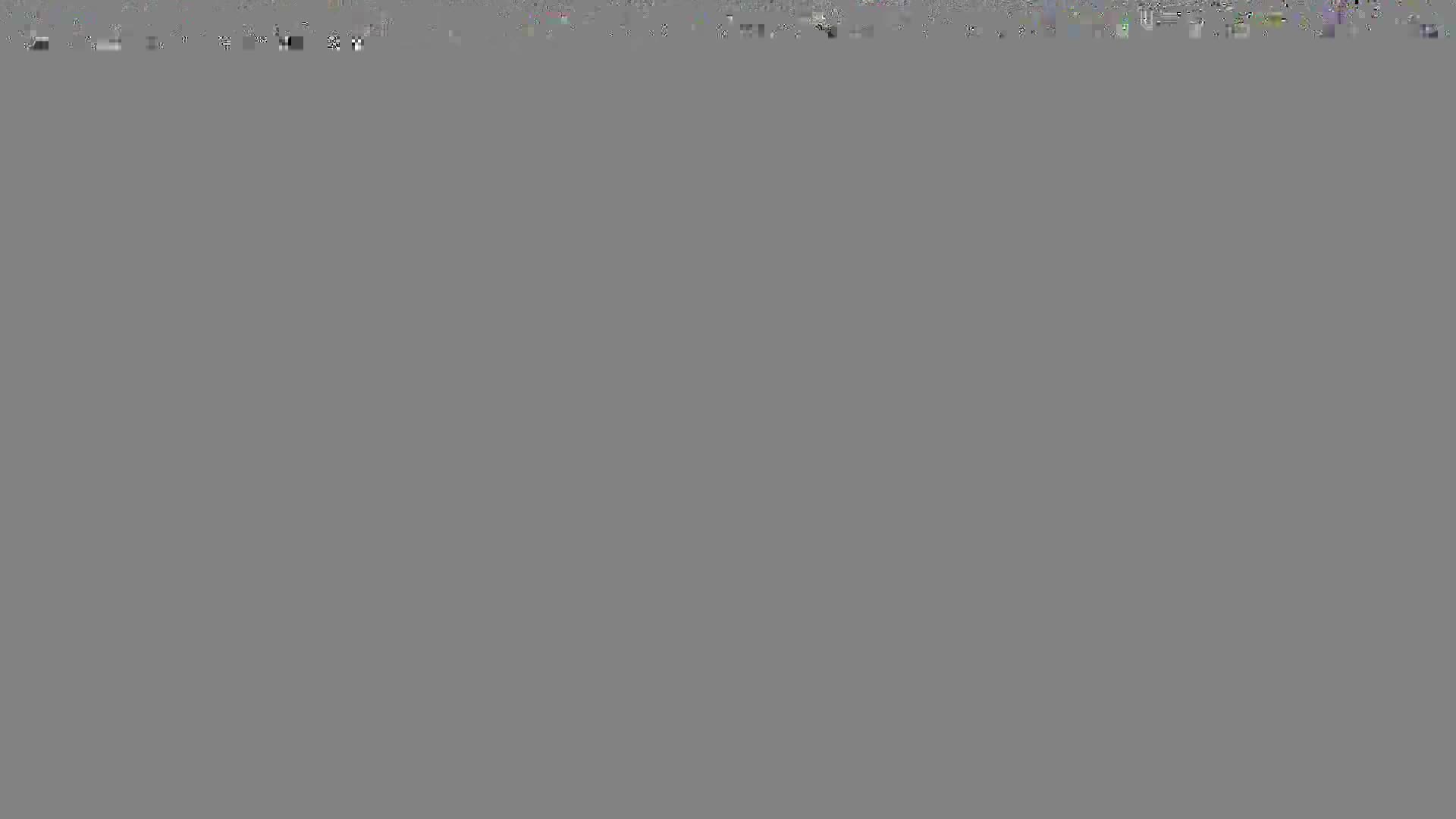 The screen is mostly gray. The top edge has a few scattered, light-colored pixels.
