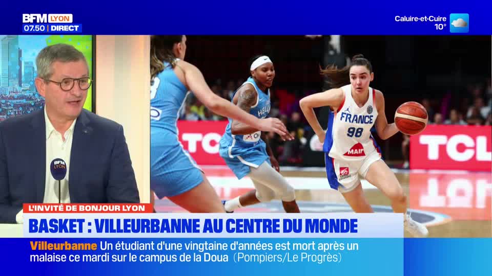 A French basketball player in a white jersey with "France 98" on it dribbles the ball. Another player in a light blue uniform moves past her, while a third player in blue guards the basket.