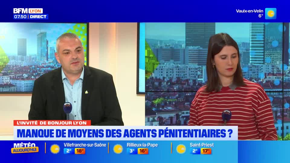 A man in a dark suit speaks into a microphone, his gaze directed slightly off-camera. Beside him, a woman in a striped sweater listens intently. The BFM Lyon broadcast displays a headline about prison guard shortages.