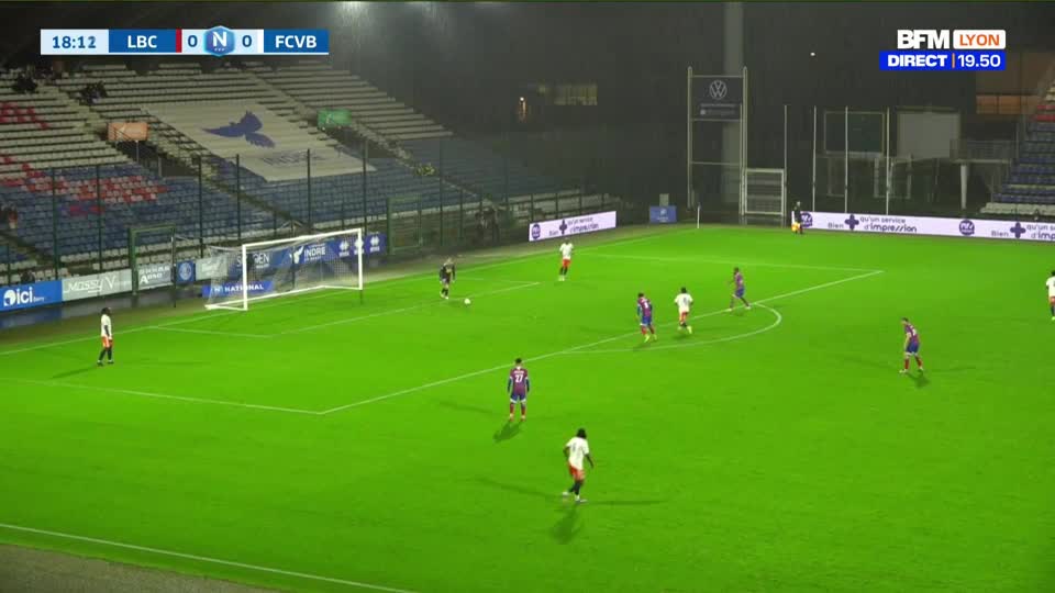 A player in white dribbles the ball up the pitch, looking for an opening. Another player in white makes a run towards the goal, with defenders closing in.