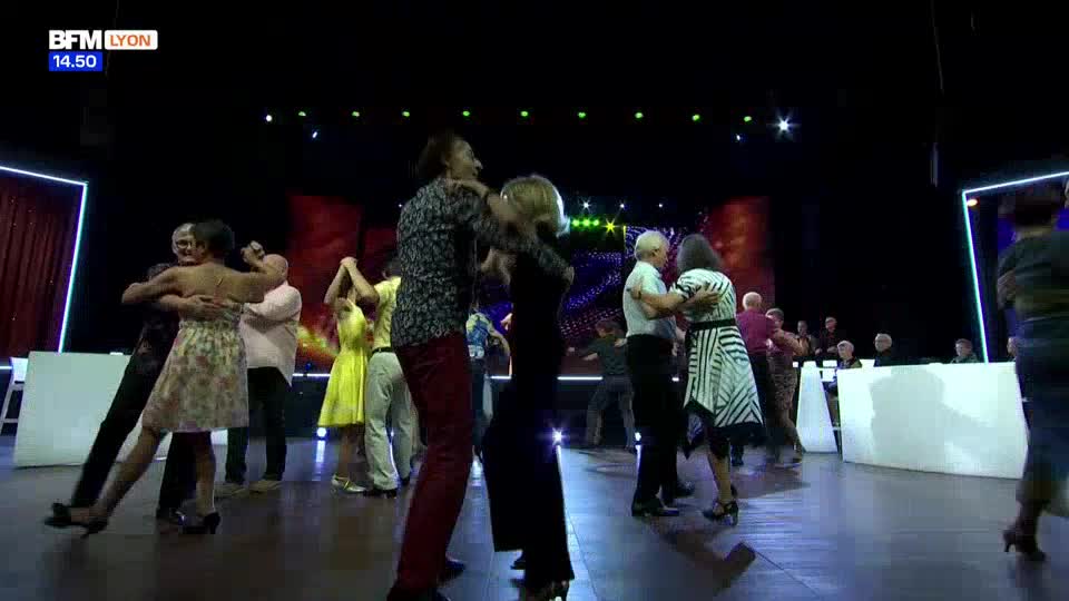 Couples dance on a stage, their movements fluid and practiced. A BFM Lyon broadcast is visible in the upper left corner.