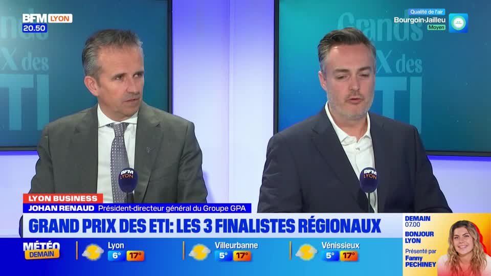Two men in suits sit at a desk in front of a screen displaying "BFM Lyon." The man on the left, Johan Renaud, looks off to the side while the man on the right speaks into a microphone. A graphic below them announces "GRAND PRIX DES ETI: LES 3 FINALISTES REGIONAUX."