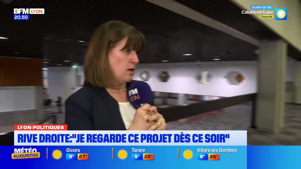 A woman speaks into a microphone, her expression intent. Behind her, the interior of a modern building stretches out, with subtle lighting and geometric wall art. A woman speaks into a microphone, her expression intent. Behind her, the interior of a modern building stretches out, with subtle lighting and geometric wall art.