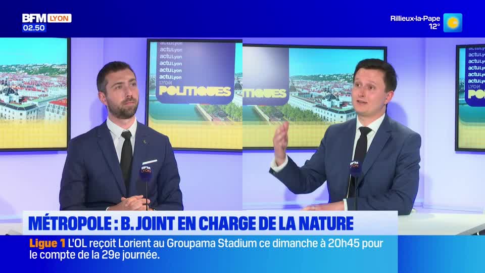 Two men in suits are seated at a desk, speaking on a BFM Lyon broadcast. The man on the right gestures with his hands as he talks.