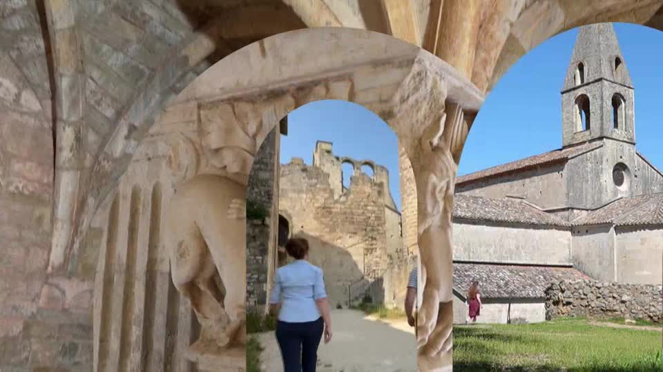 A woman in a blue shirt walks through an arched stone entryway toward ancient ruins. To the right, a stone church with a tall steeple stands under a clear blue sky.