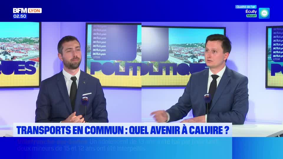 Two men in suits sit at a desk in front of a screen displaying "BFM Lyon." The man on the right gestures with his hand as he speaks.