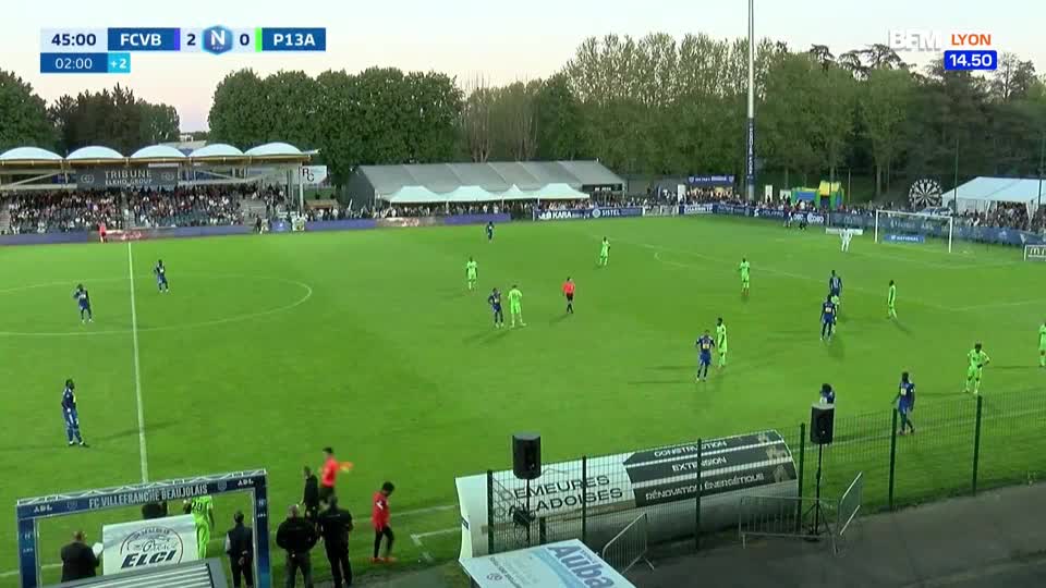Players in blue jerseys are moving across the green pitch, some with the ball. The scoreboard indicates it's 45 minutes into a match, with the home team leading 2-0.