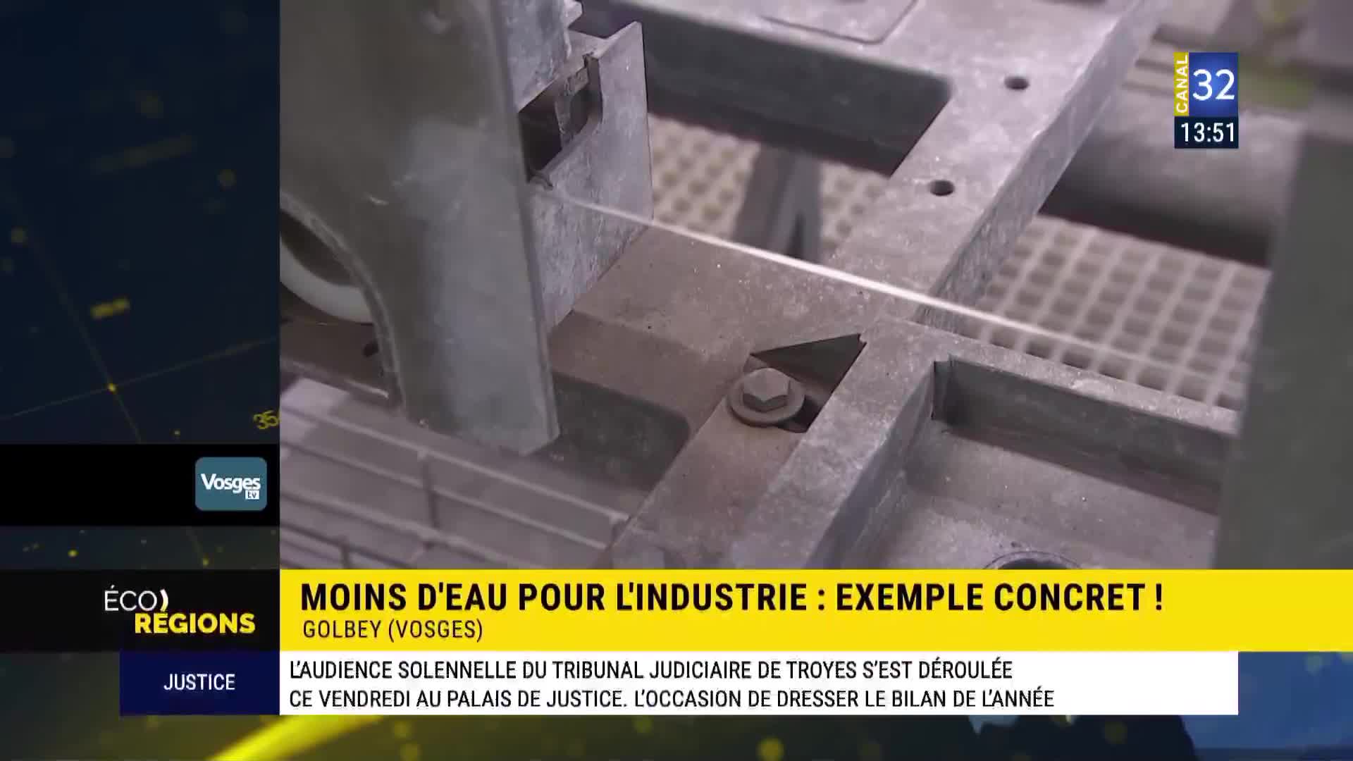 A metal blade moves steadily through a piece of material. This is part of a report from Canal 32 about industry in the Vosges region of France.