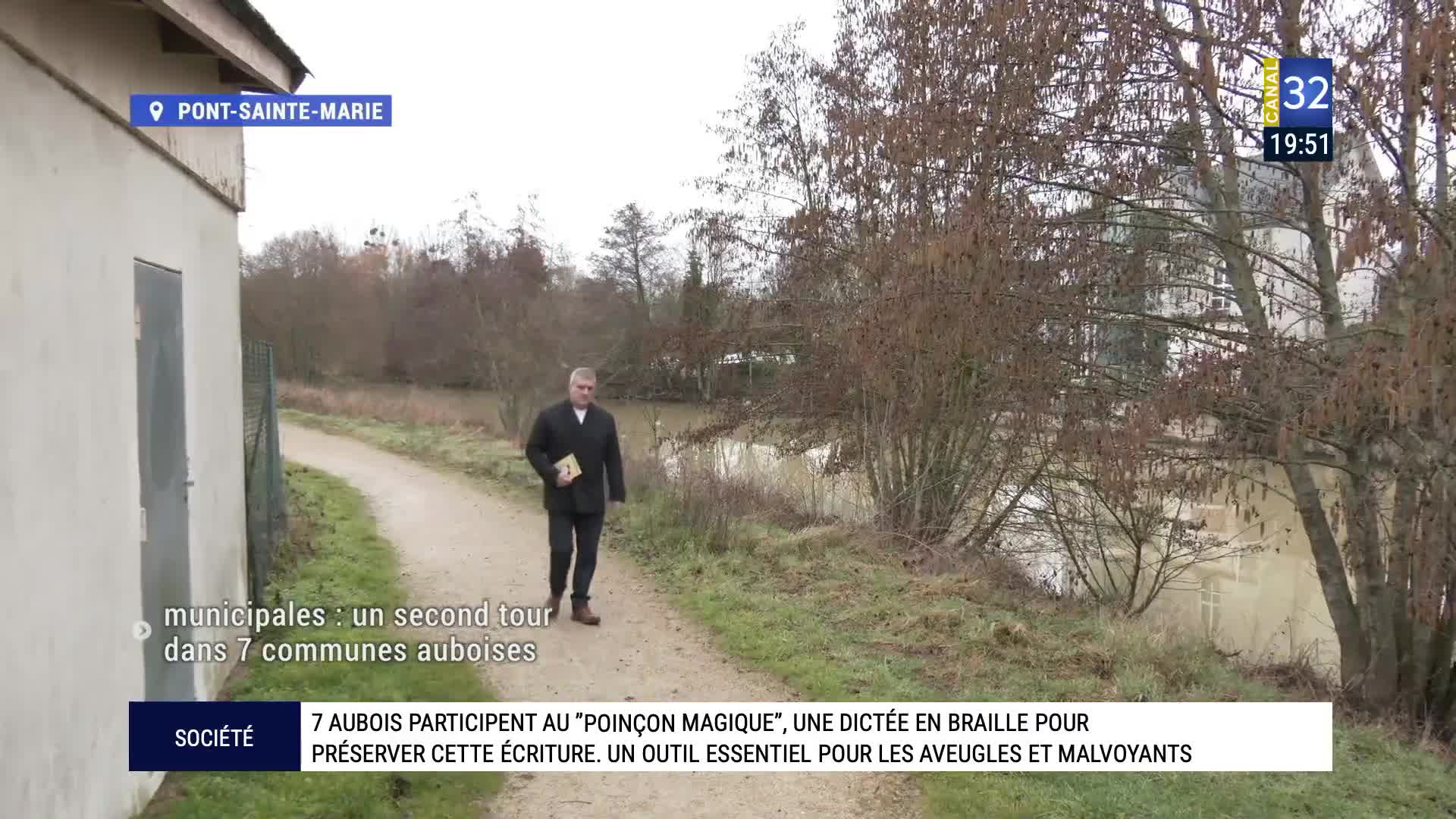 A man walks along a canal path near Pont-Sainte-Marie. He carries a book under his arm. A man walks along a canal path near Pont-Sainte-Marie. He carries a book under his arm.
