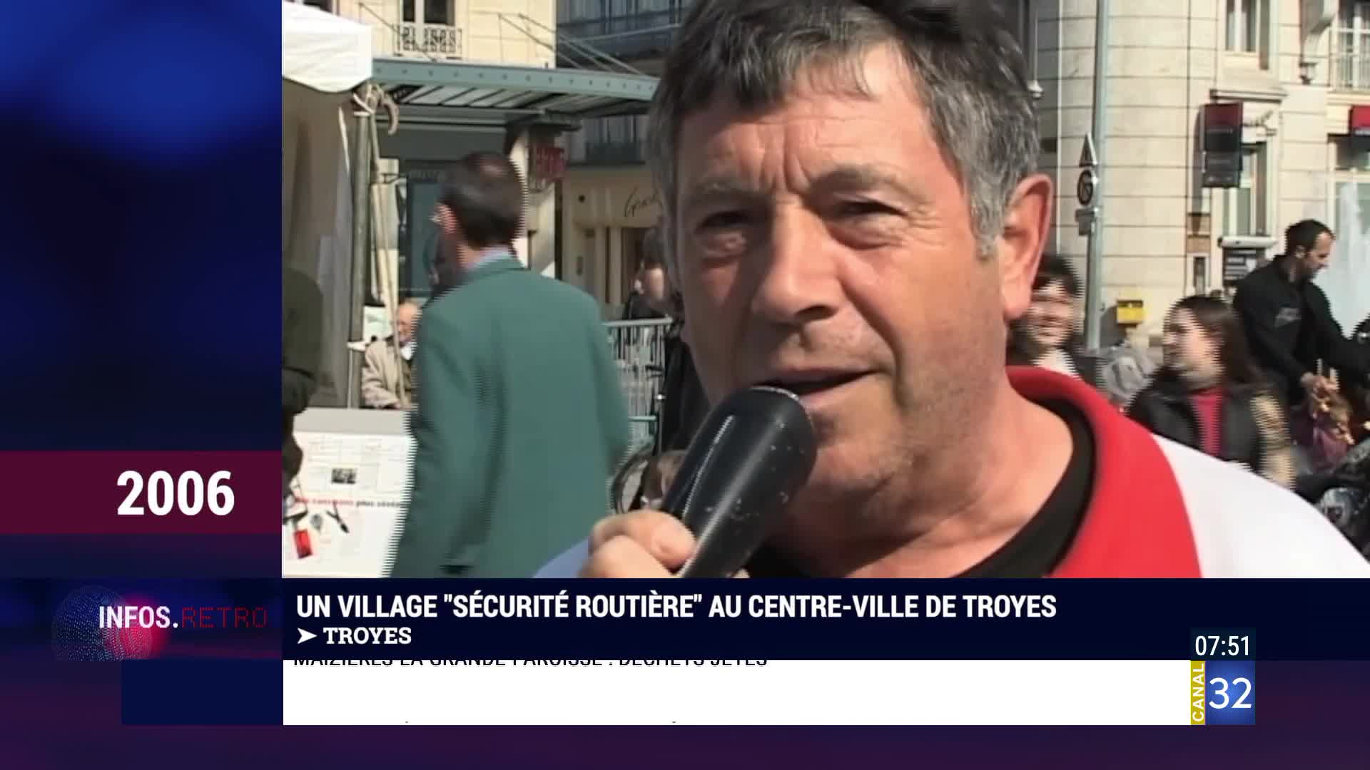 A man speaks into a microphone, his face close to the camera. Behind him, a crowd mills about in the bright sun of Troyes. A man speaks into a microphone, his face close to the camera. Behind him, a crowd mills about in the bright sun of Troyes.