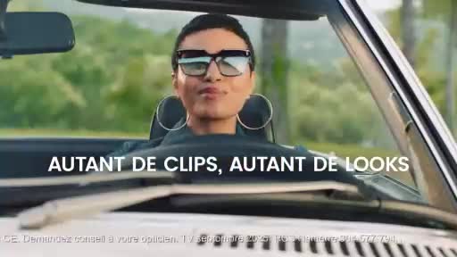 A person with large hoop earrings and sunglasses sits in a convertible, looking directly at the camera.  The French text "AUTANT DE CLIPS, AUTANT DE LOOKS" is visible, likely a CNews advertisement.
