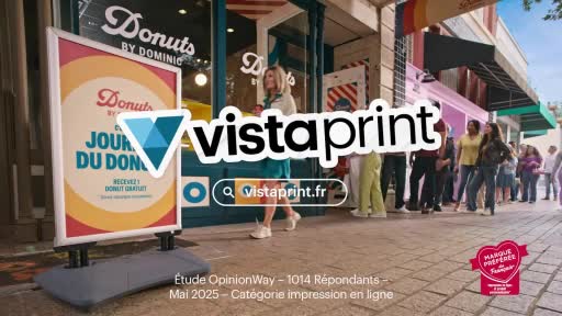 A woman in a teal dress walks past a "Donuts by Dominic" shop, where a queue of people stretches down the sidewalk. A sign advertises "Jour du Don" with a free donut offer.