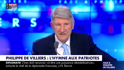 A man with grey hair speaks into a microphone, his face illuminated by the studio lights. Behind him, the CNews logo flashes on a bright blue screen.