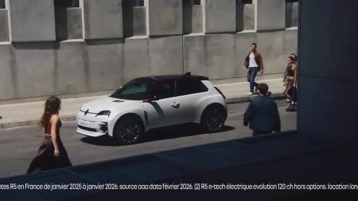 A white electric car glides down a Parisian street. People walk past, some looking towards it. A white electric car glides down a Parisian street. People walk past, some looking towards it.