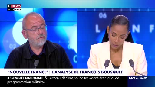 A man with glasses and a gray beard looks to his left, his expression thoughtful. Beside him, a woman in a cream jacket looks down, her gaze fixed on something out of frame. A man with glasses and a gray beard looks to his left, his expression thoughtful. Beside him, a woman in a cream jacket looks down, her gaze fixed on something out of frame.