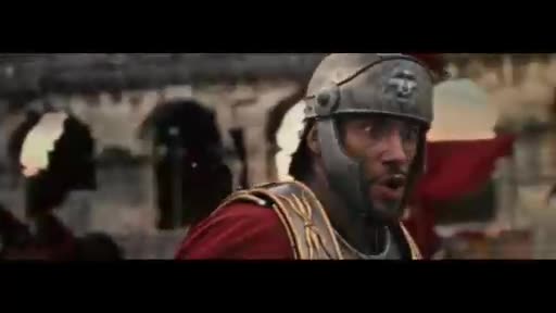 A Roman soldier in a metal helmet and red tunic shouts, his mouth open in surprise. Behind him, other figures in similar attire move through a stone structure. A Roman soldier in a metal helmet and red tunic shouts, his mouth open in surprise. Behind him, other figures in similar attire move through a stone structure.