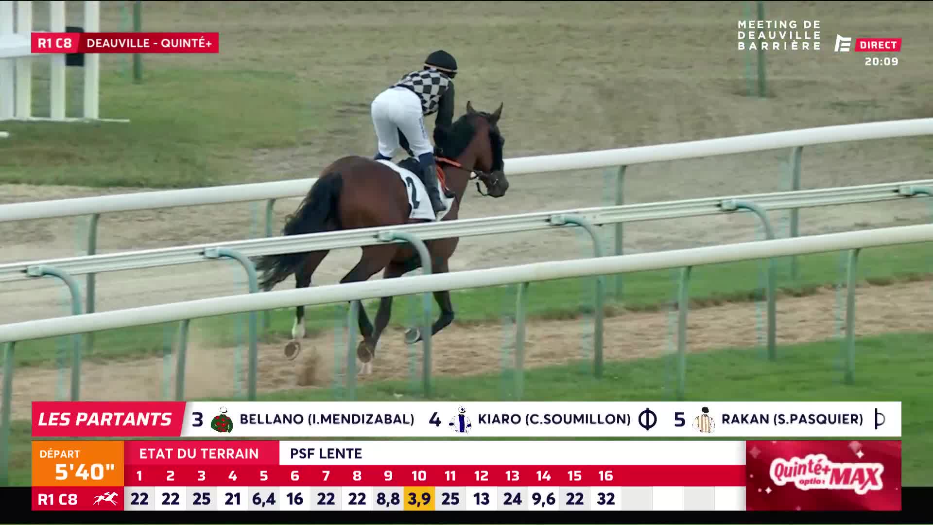 A chestnut horse, ridden by a jockey in a checkered cap, leaps over the track. The Equidia broadcast shows the Deauville race is well underway.
