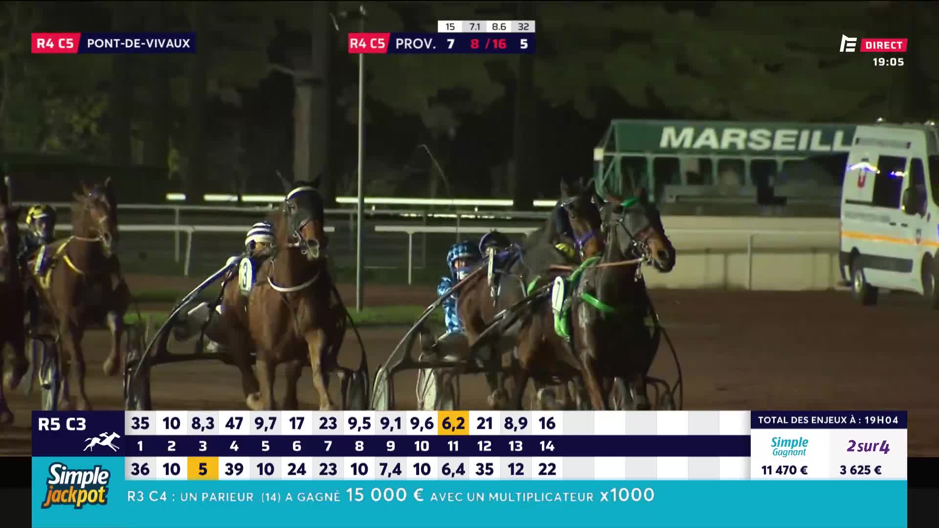 The horses, harnessed to their sulkies, are thundering down the track. The drivers, in their colorful silks, urge their mounts forward, heads bobbing as they navigate the course.
