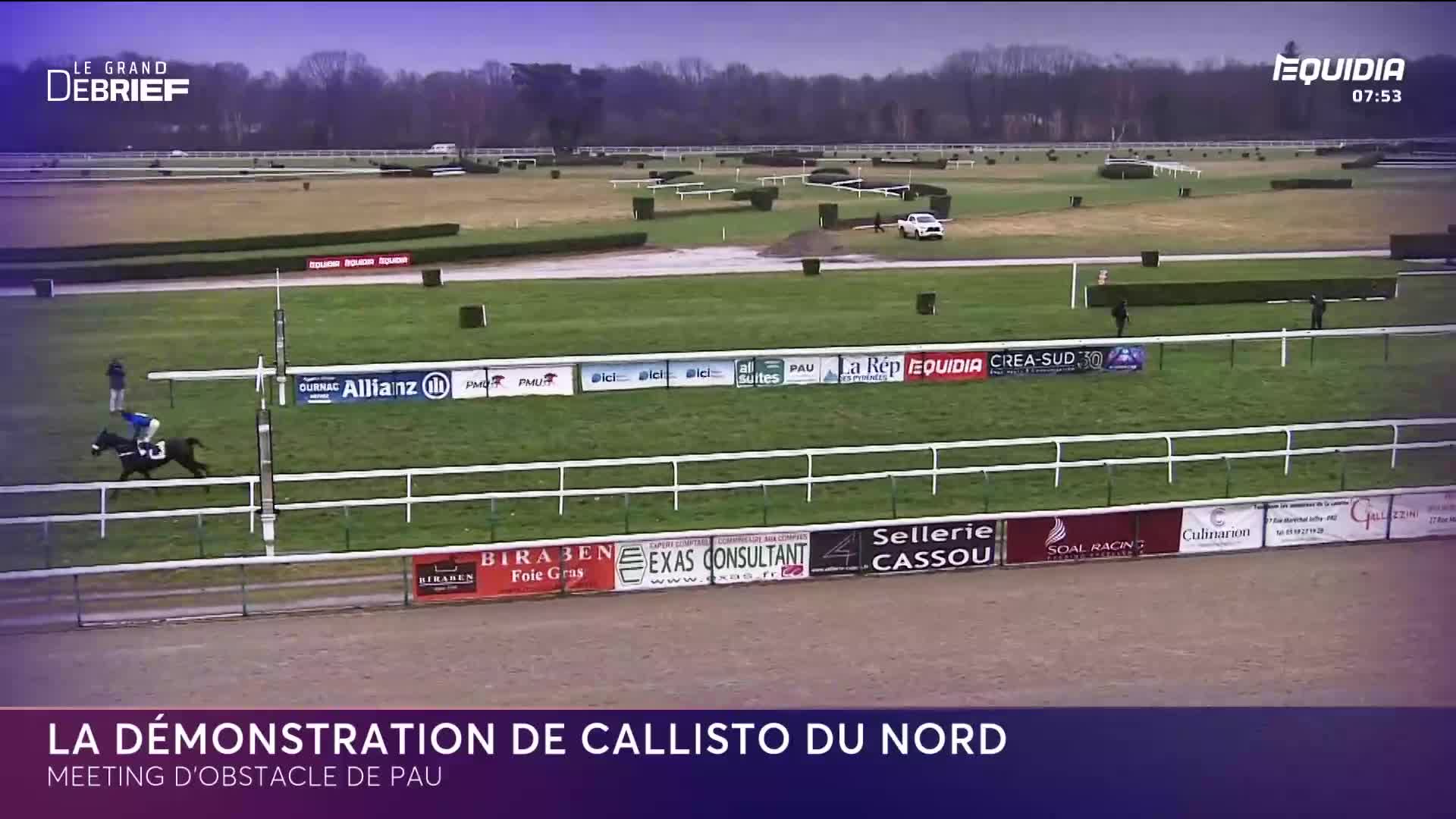 A lone horse and rider gallop across the track, their blue silks stark against the green turf. Behind them, a white car navigates the course, a stark contrast to the equestrian event.