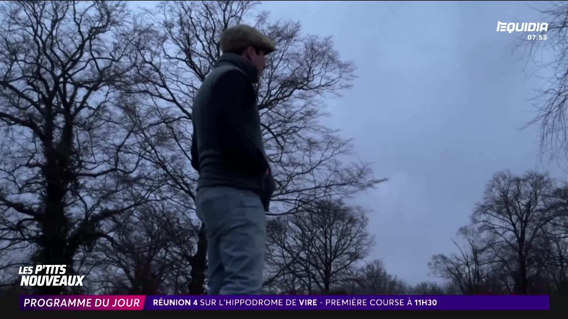 A man in a cap stands with his hands in his pockets, looking out at the bare trees. The sky above is a dull grey, hinting at the early morning in France. A man in a cap stands with his hands in his pockets, looking out at the bare trees. The sky above is a dull grey, hinting at the early morning in France.