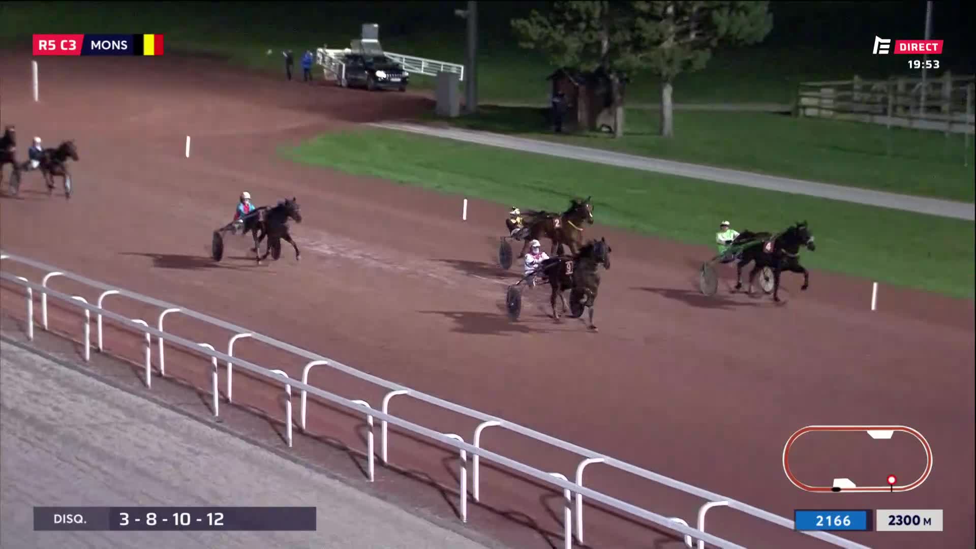 The horses are thundering down the track in Mons, their hooves kicking up dust. A sulky driver in a white and blue silks leans forward, urging his mount on. The horses are thundering down the track in Mons, their hooves kicking up dust. A sulky driver in a white and blue silks leans forward, urging his mount on.