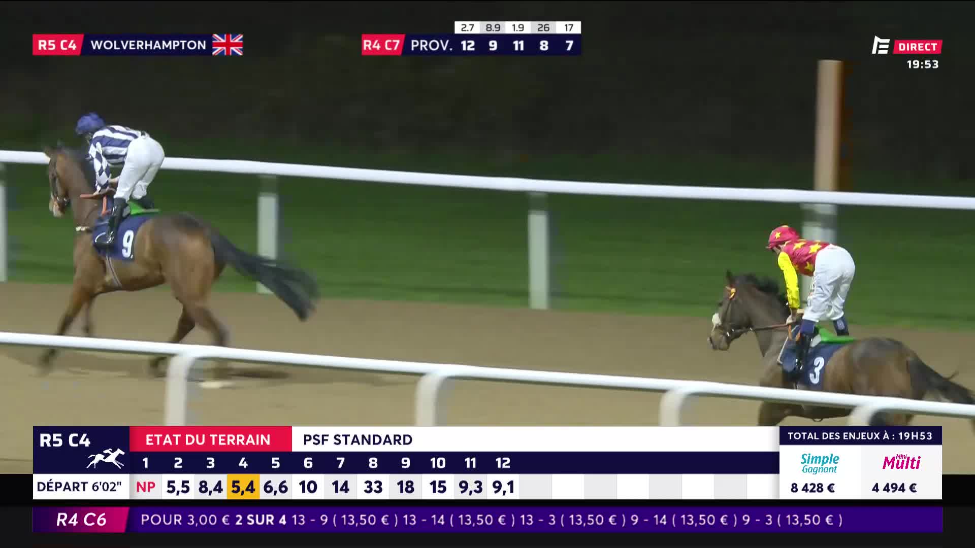 A jockey in a blue and white striped silks leans forward, urging his horse on. Another rider, in yellow and red, is slightly behind, pushing their mount.