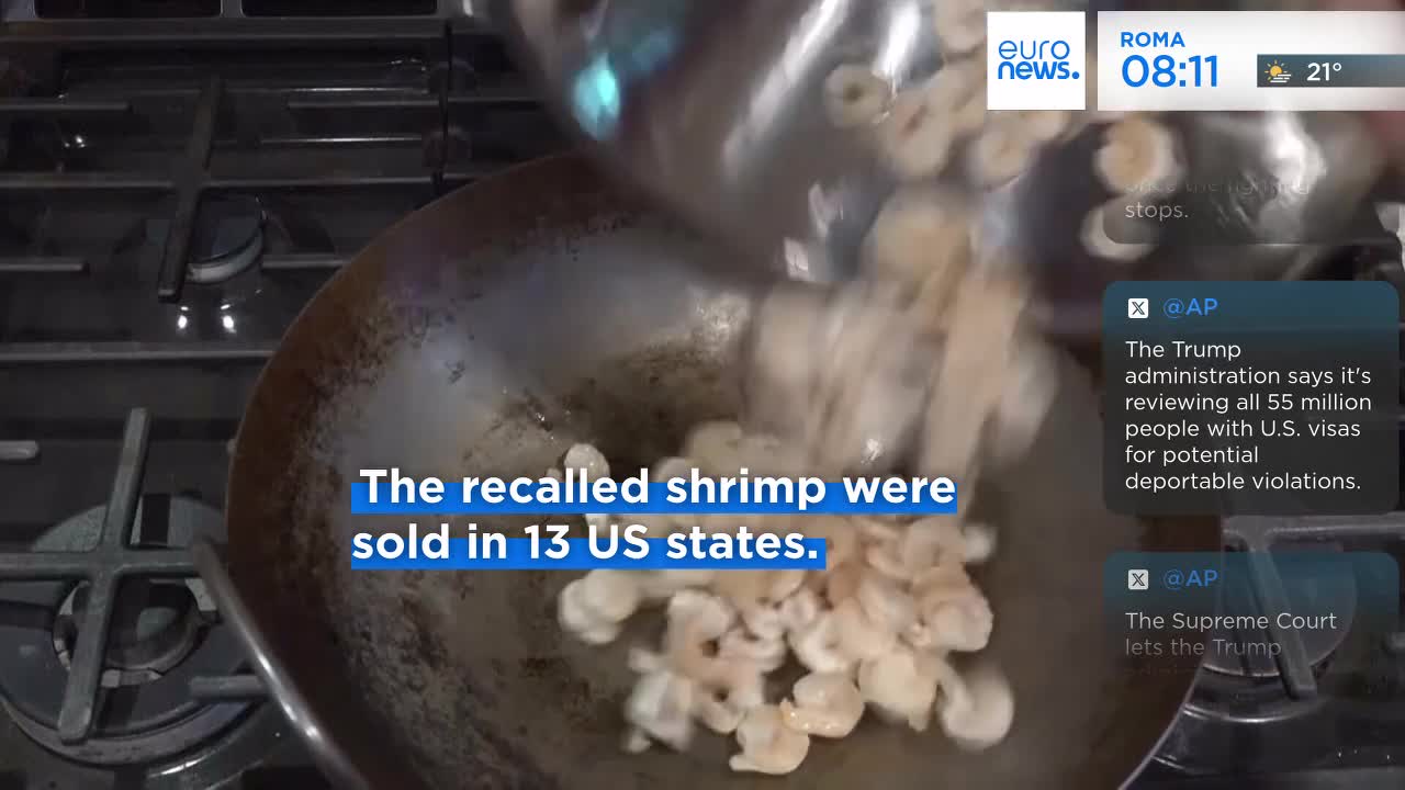 Shrimp are being poured from a pan into a larger wok, the action captured by Euronews English. The on-screen text states the recalled shrimp were sold in the United States.
