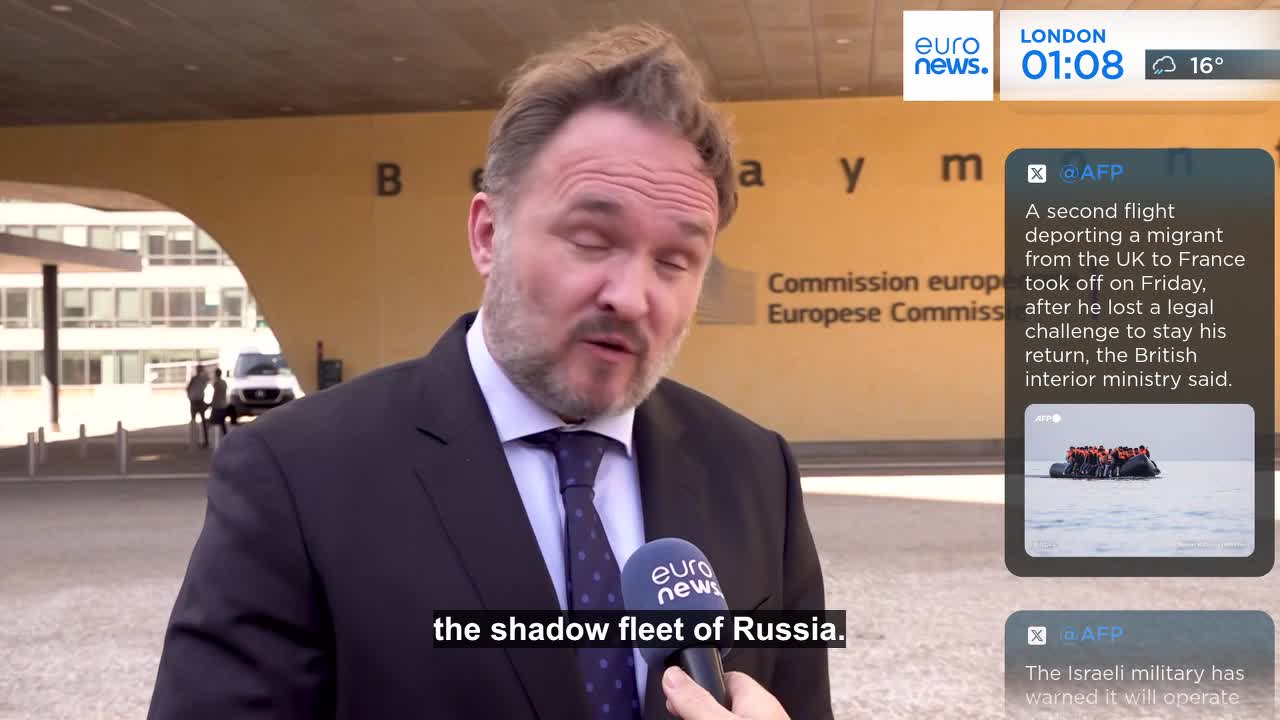 A man in a suit speaks into a microphone, the Euronews logo visible. Behind him, a building with the words "Commission europe" is partially visible.
