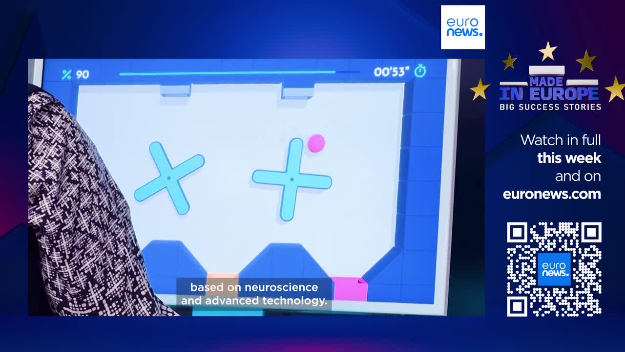 A pink ball hovers above a light blue cross shape on a screen. Another cross shape spins slowly to its left, its arms angled differently.