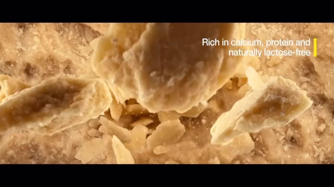 Chunks of cheese are breaking apart, revealing a textured, granular interior. The text "Rich in calcium, protein and naturally lactose-free" appears on screen, a detail that might be of interest to French consumers following Euronews English. Chunks of cheese are breaking apart, revealing a textured, granular interior. The text "Rich in calcium, protein and naturally lactose-free" appears on screen, a detail that might be of interest to French consumers following Euronews English.