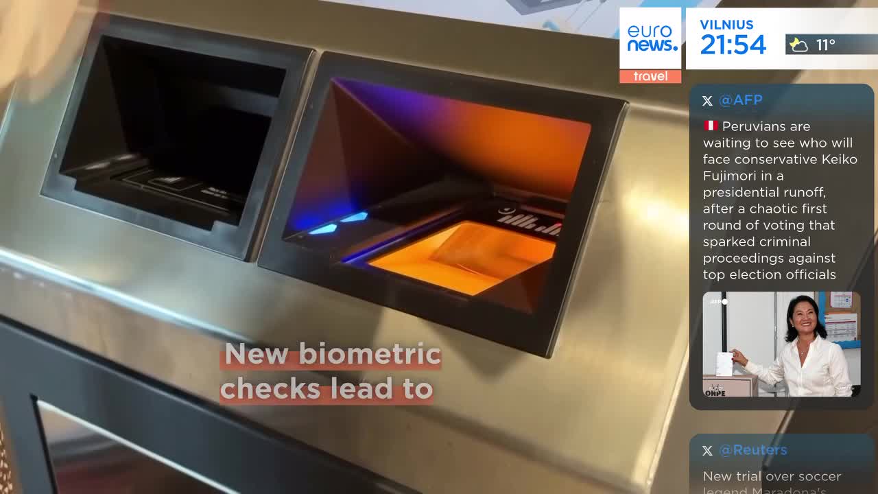 A scanner glows with orange and blue light as a hand is placed on it. This new biometric check is part of the travel process.