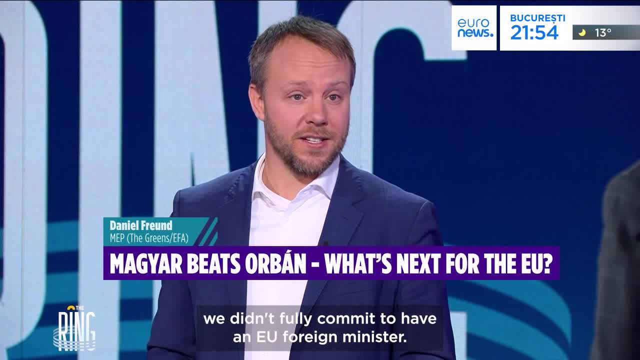 A man in a blue suit speaks, his words appearing as subtitles below him. The Euronews logo is visible in the corner, alongside a Bucharest time and temperature.