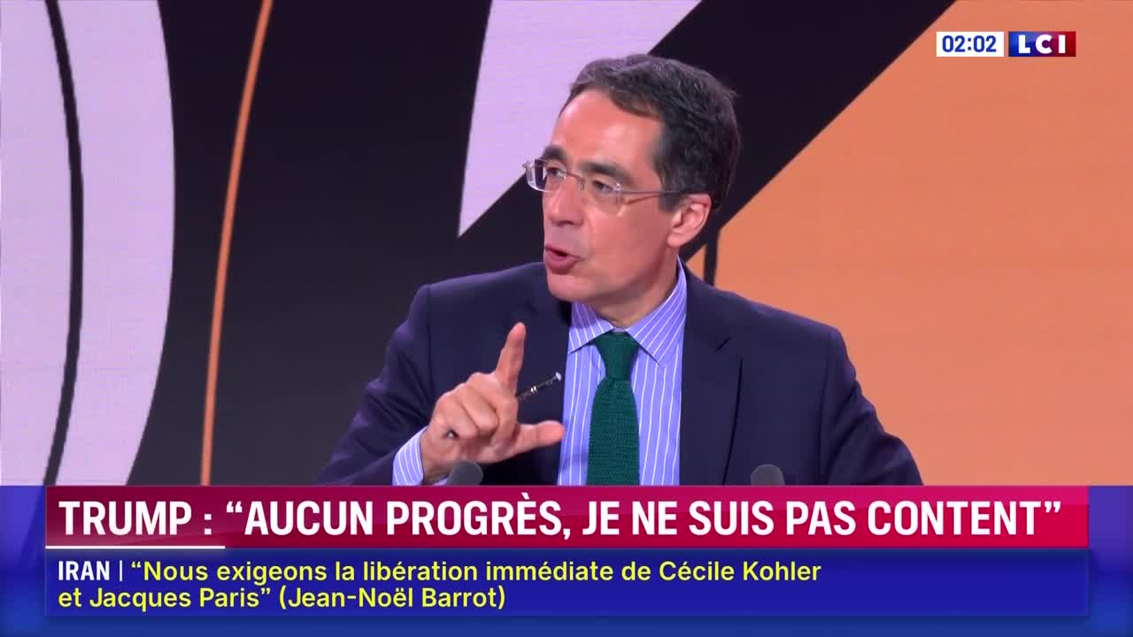 A man in a suit and tie gestures emphatically while speaking on a news program, LCI. The lower third of the screen displays a headline about Trump and Iran.
