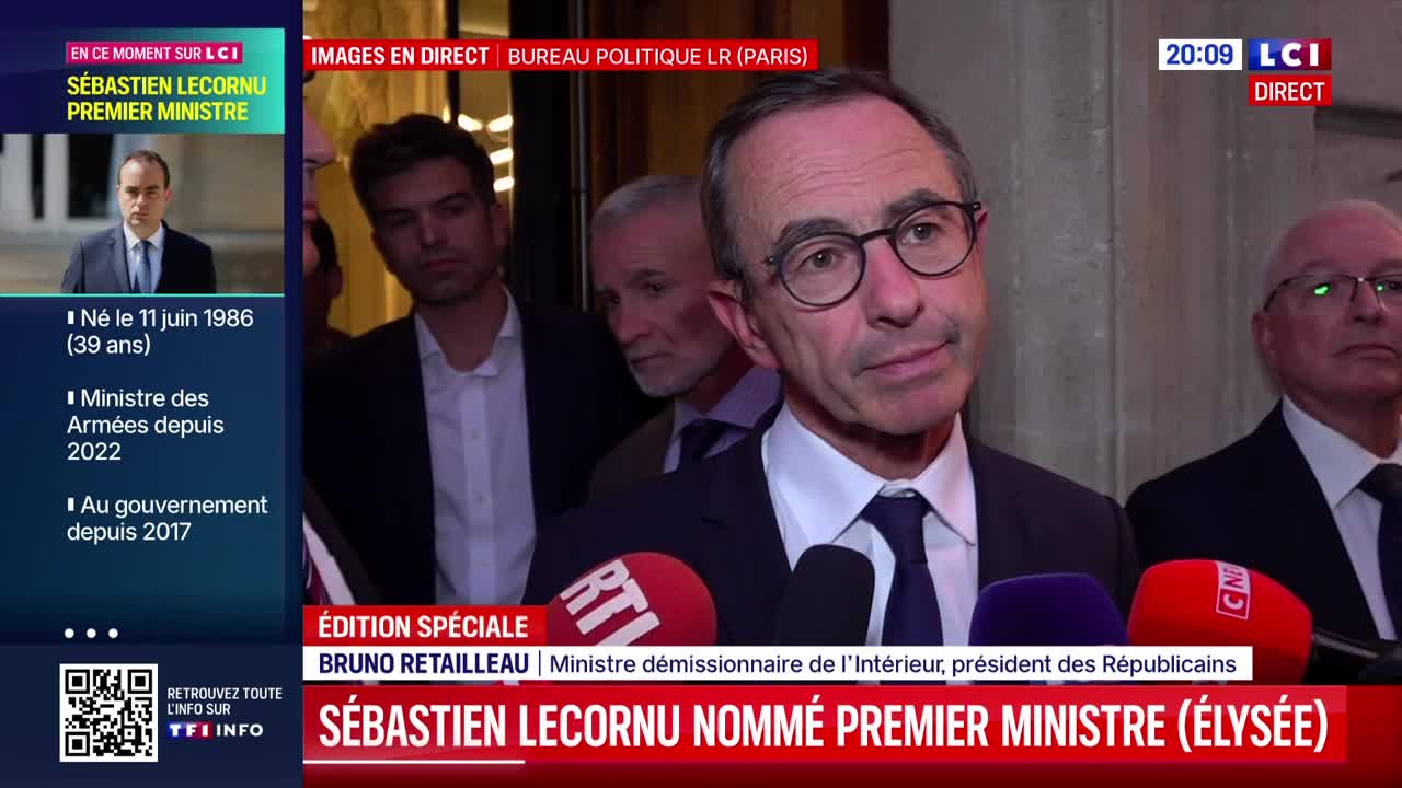 A man with glasses, likely a politician, is speaking into several microphones, flanked by others in suits. The LCI logo and a breaking news banner about Sébastien Lecornu being named Prime Minister are visible.
