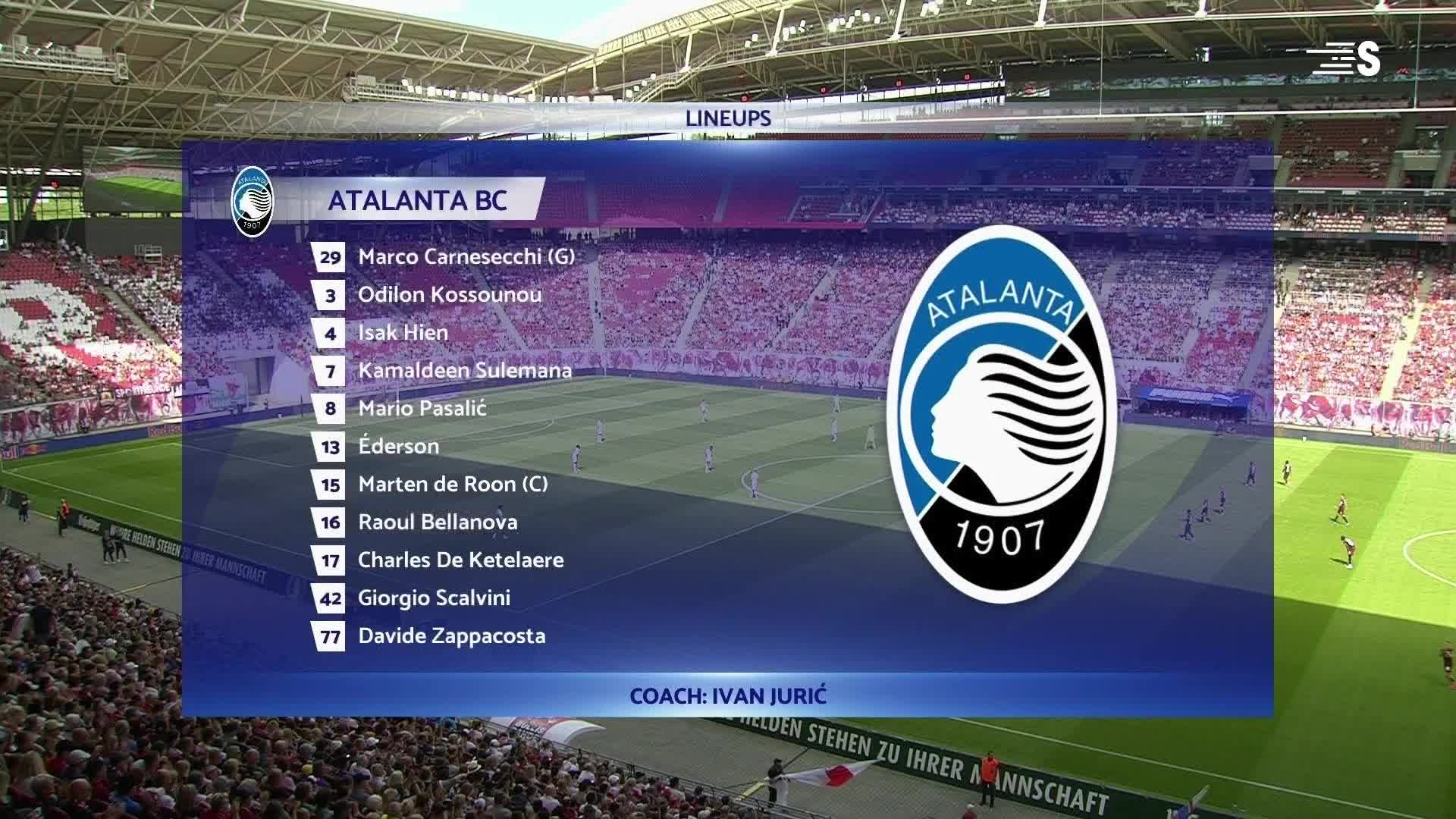 The Atalanta lineup is displayed on the screen, while the players warm up on the pitch below. The crowd in the stands is a sea of red and white, ready for the match.
