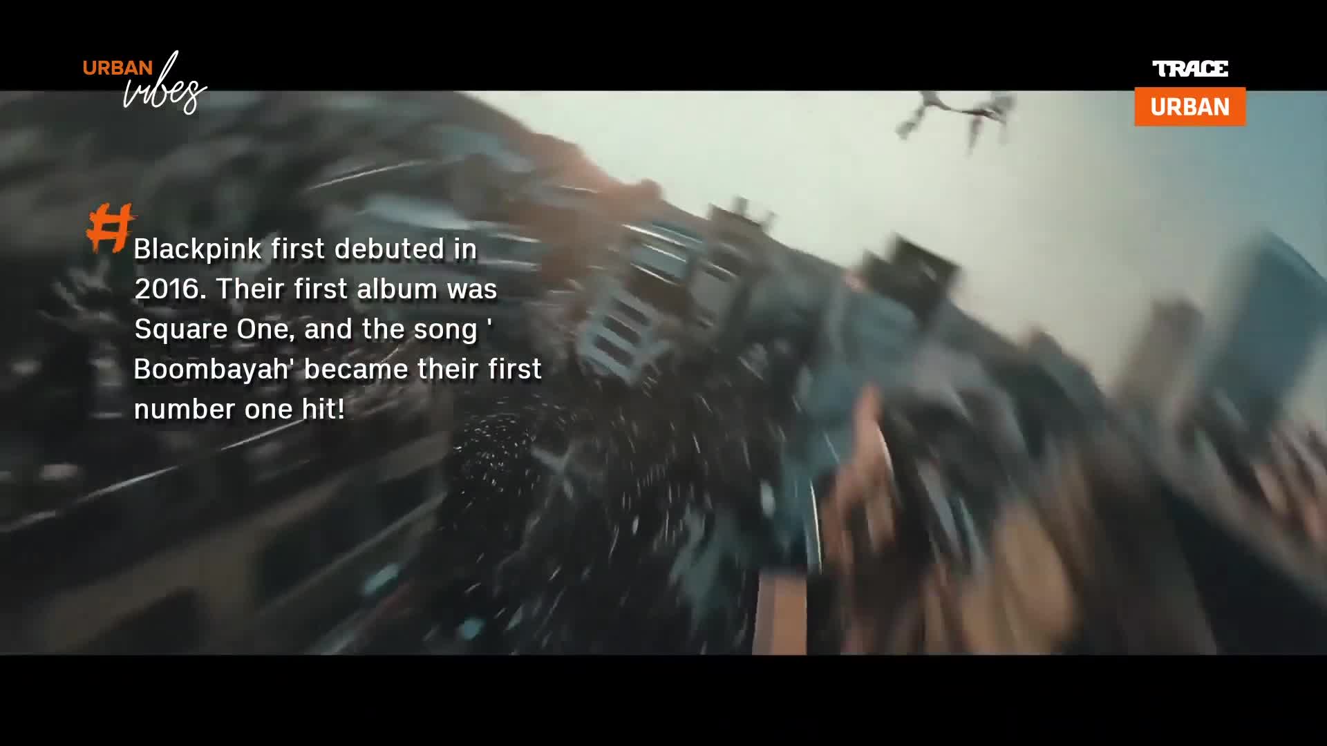 Debris is swirling and flying across the screen, creating a chaotic, dynamic effect. The camera seems to be moving with the action, as if caught in the middle of the scene.
