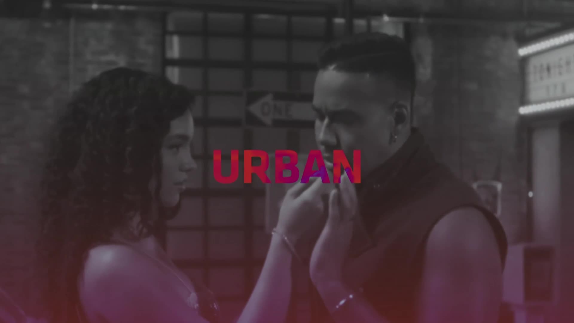 A man and woman hold hands, their faces close in the dim light of a Parisian night. The word "URBAN" glows in bold red letters between them.