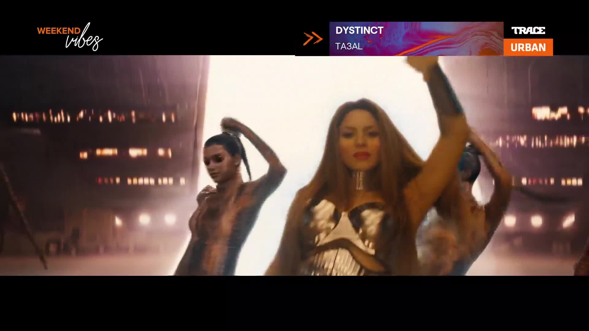 A woman with long, flowing hair in a metallic top moves her arms with confidence. Another woman to her left, with her hair pulled back, strikes a pose. The Trace Urban logo is visible at the top right. A woman with long, flowing hair in a metallic top moves her arms with confidence. Another woman to her left, with her hair pulled back, strikes a pose. The Trace Urban logo is visible at the top right.