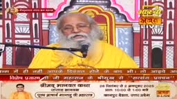 A man in a yellow robe, speaking into a microphone, is the focus of the Aastha Bhajan broadcast. The screen displays text in Hindi, advertising a religious event in India.

