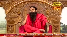 A man in a red robe sits on a carved wooden chair, speaking into a microphone. The Aastha Bhajan logo is visible above him, and text scrolls across the bottom of the screen.
A man in a red robe sits on a carved wooden chair, speaking into a microphone. The Aastha Bhajan logo is visible above him, and text scrolls across the bottom of the screen.