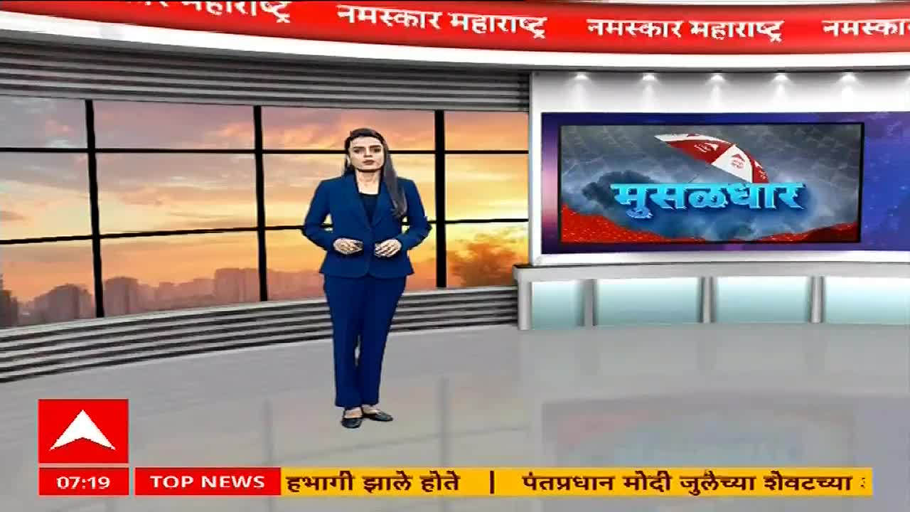 A woman in a blue suit stands in a studio, framed by a large window and a screen displaying "Musaldhar" in Marathi. The ABP Majha logo is visible in the corner, indicating a news broadcast from India.

