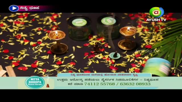 On a dark surface strewn with flower petals, small oil lamps burn brightly. Wisps of smoke rise from an incense cone, and the Ayush TV logo sits in the corner.
